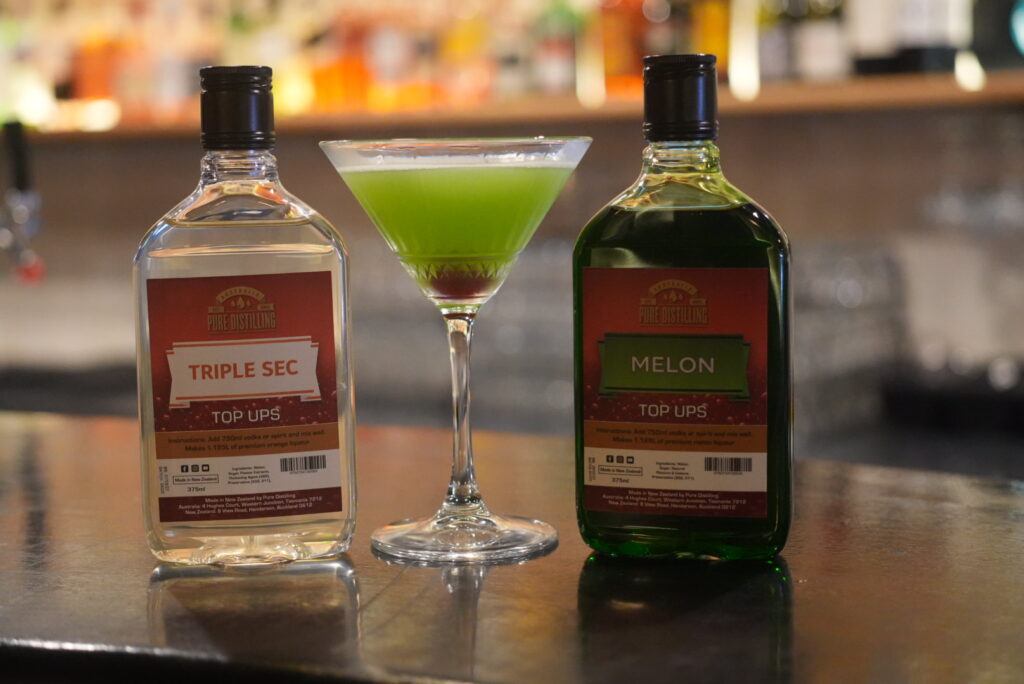 Cocktail and liquor bottles on bar counter
