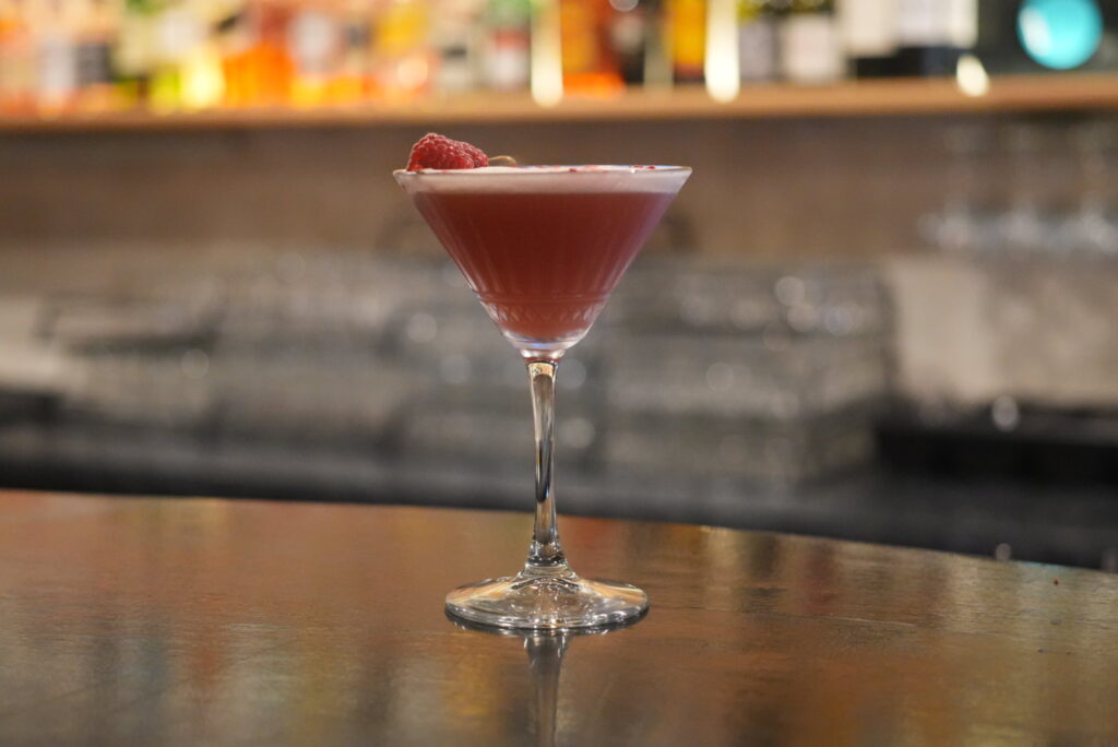 Raspberry cocktail on bar counter