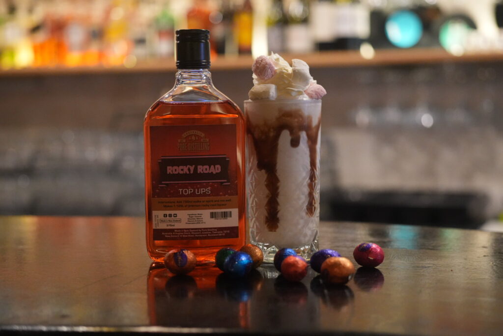 Rocky Road liquor bottle beside milkshake on bar